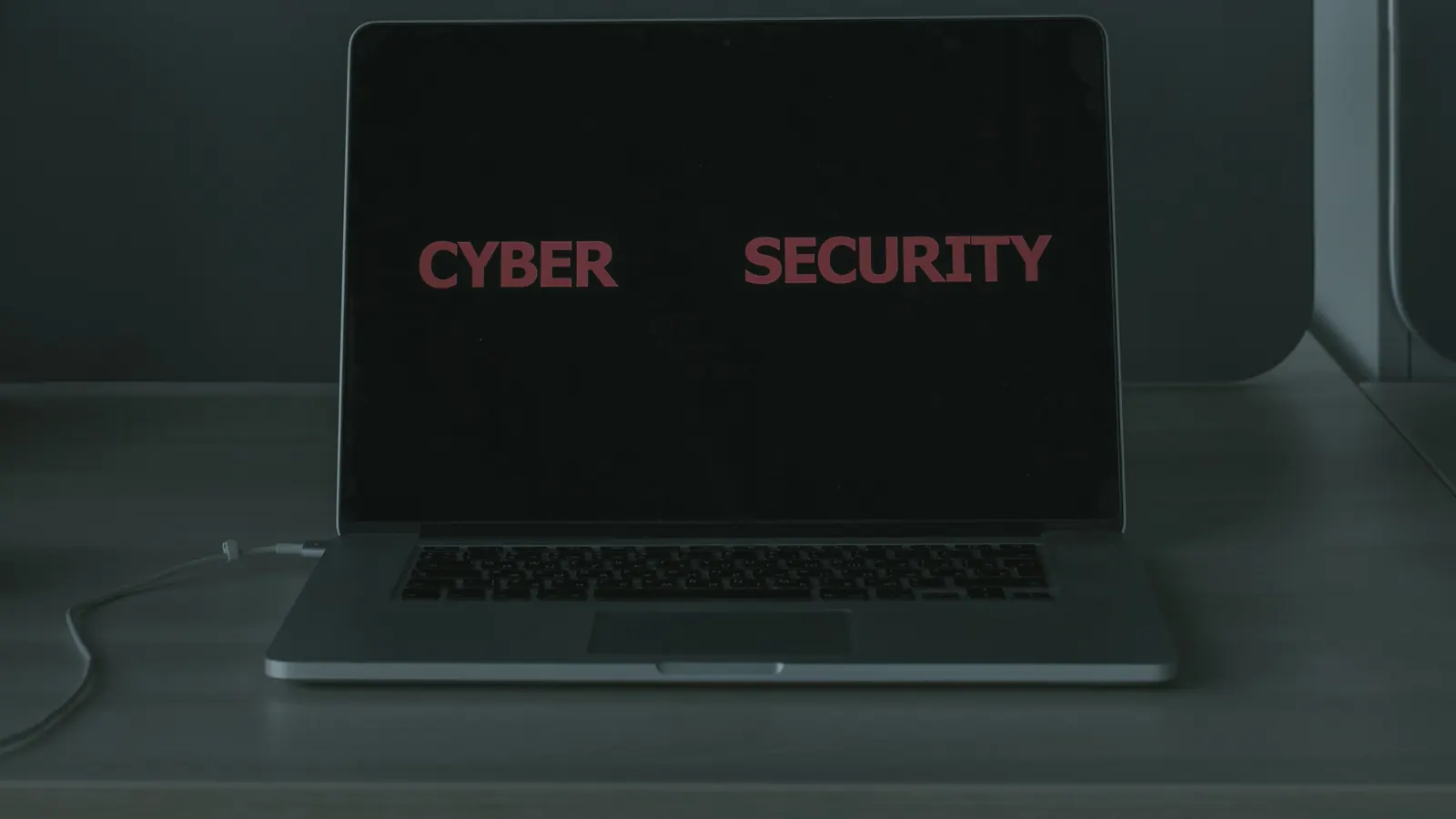 A laptop screen displaying the words "Cyber Security"